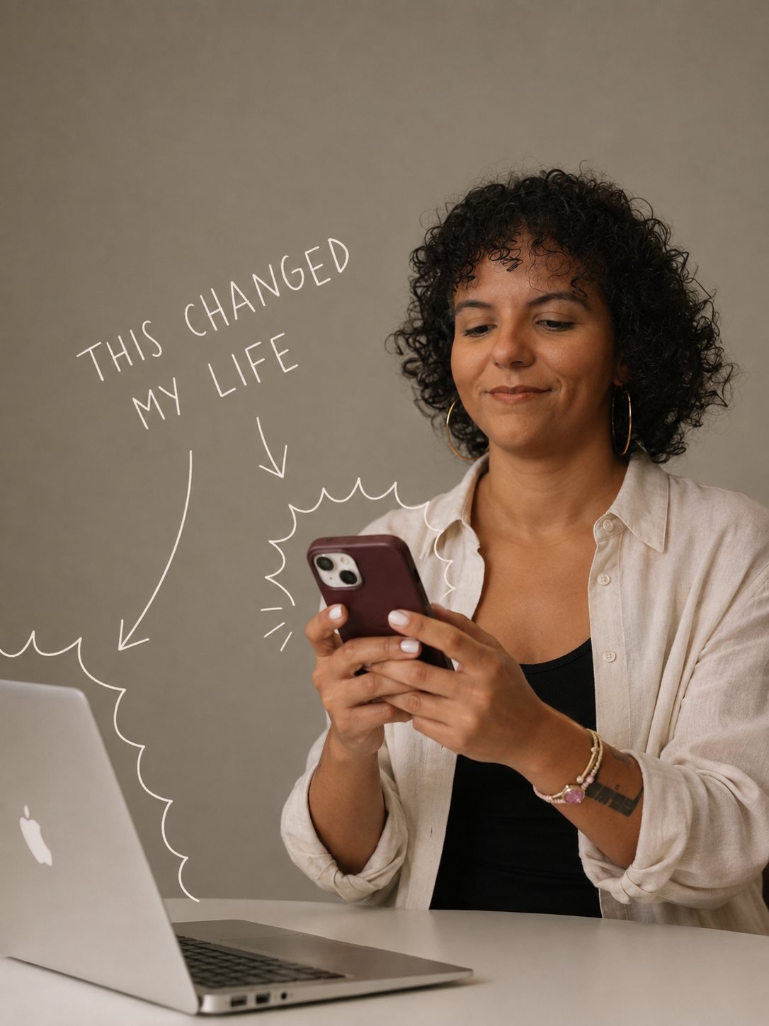 Raquel Camargo at her laptop reading something on her phone, beside a handwritten note reading This changed my life