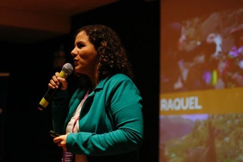 Raquel speaking on stage